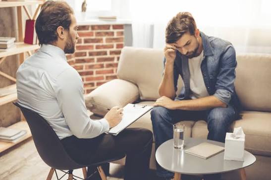 Licensed therapist taking progress notes during a counseling session